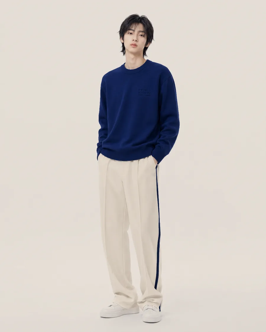 The Origin capsule worn — Obang Blue crewneck with Attica Stone pleated trousers